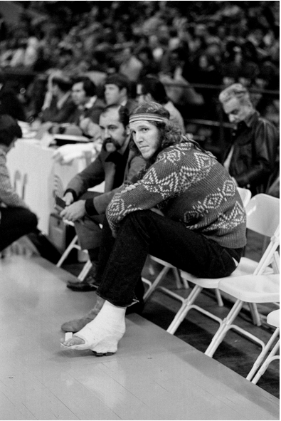 Walton watching his Portland Trail Blazers play in 1975, his foot immobilized by an injury. Bettman/Getty Images 